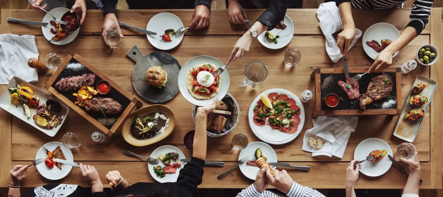 Overhead table setting with prepared protein dishes, representing Deli Star's food and partner ecosystem.